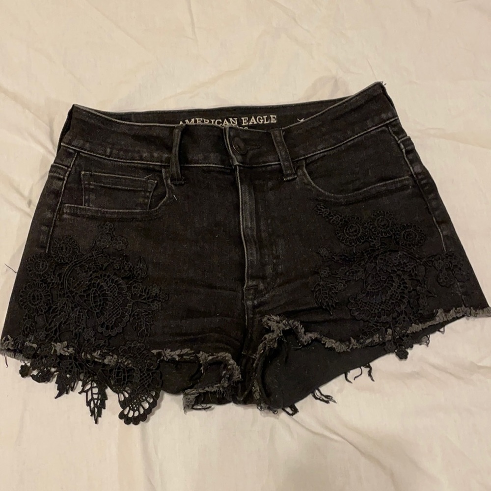 Black denim shorts with floral stitching